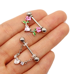 Detail of mushroom and rose nipple rings with pink enamel and sparkling zircon heart chains