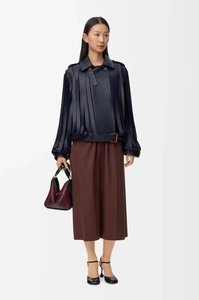 Chic dark blue leather jacket featuring vertical fringe and gold buckle accents