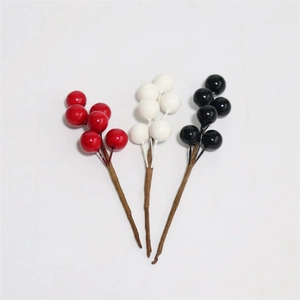 Detailed view of red, white, and black artificial berry stems for festive home decoration