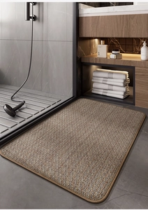 Detail of the woven texture and brown trim of the absorbent memory foam bathroom mat