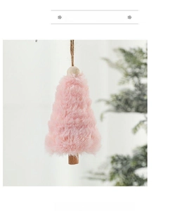 Pink plush Christmas tree ornament with wooden beads hanging on a minimalist natural background