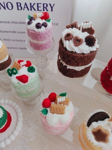 Macro detail of realistic mini strawberry and chocolate cake scented aroma candles