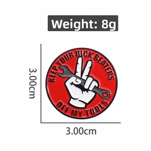 Close-up of red enamel gesture wrench pin, 3cm diameter badge weighing 8g