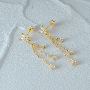 Detailed close-up of S925 sterling silver gold fringe earrings with clear gemstones