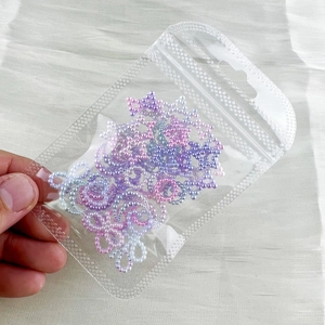 Detail of colorful pearlescent star beads in clear bag for Lolita eye makeup decoration