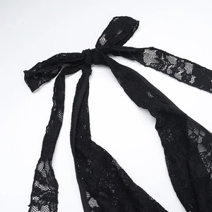 Detailed macro view of delicate black lace fabric and secure neck tie-up detail