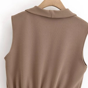 Detail of brown sleeveless top featuring lapel collar and crepe textured fabric surface