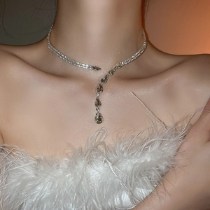 Detail of silver double layer necklace with clear teardrop crystals on model