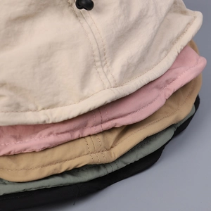 Detail of colorful foldable bucket hats showing fabric texture and reinforced stitching