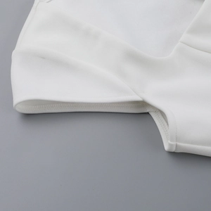 Macro detail of high-quality stitching and seam finishing on white mini dress sleeve