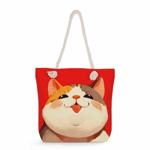 Detail of red canvas tote bag featuring a cute calico cat illustration and cotton rope handle