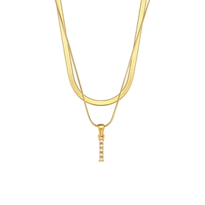 Close-up of double layer gold snake chain necklace with elegant vertical pearl pendant