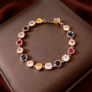 Detail of 18K gold plated bracelet with colorful heart and square-shaped gemstones
