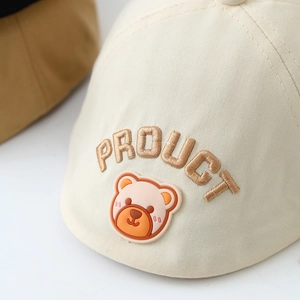 Kids cream baseball cap with 3D brown PRODUCT embroidery and cute bear badge detail