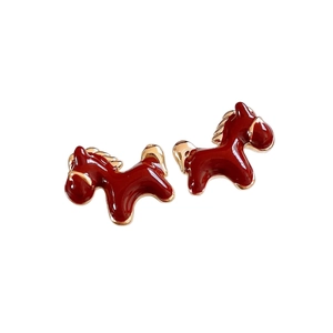 Elegant 18K gold plated horse pendant earrings with red enamel finish on white background
