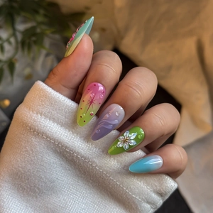 Pastel gradient press-on nails with 3D floral and water drop designs on stiletto shapes