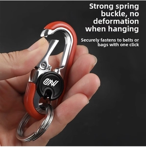 Detail of durable spring buckle keychain in orange and silver with dual key rings