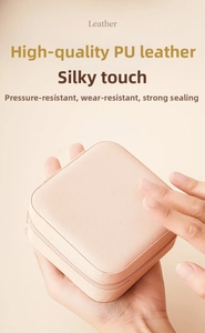 Close-up of portable pink PU leather jewelry box with zipper closure and durable texture