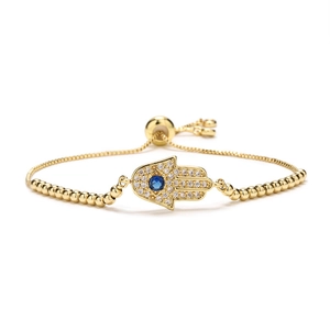 Gold Hamsa Hand bracelet with blue eye zircon and adjustable beaded chain on white background