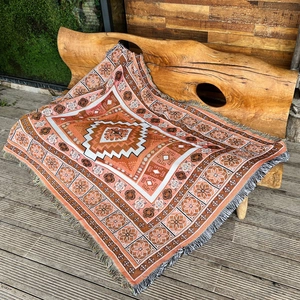 Bohemian orange cotton woven camping blanket with geometric patterns and fringe tassels