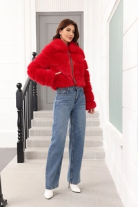 Detailed full-length view of a red faux fur coat styled with jeans and white pointed boots
