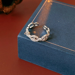 Macro shot of silver-plated adjustable ring with cubic zirconia pig nose chain design