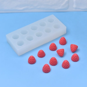 10-cavity strawberry silicone mold for DIY soap, candle and cake baking on blue background