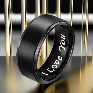 Macro shot of black brushed titanium ring with I Love You engraving inside