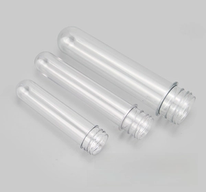 Detailed macro view of three transparent PET preform tubes with threaded necks and mold marks