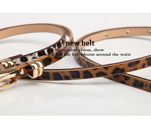 Macro shot of stylish leopard print skinny belt with a polished gold metal buckle