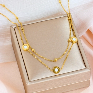 Minimalist double-layered gold necklace with Roman numerals and white shell pendants