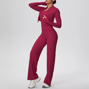 Three-piece yoga set featuring a zipper jacket, crop top, and flare pants in deep berry red