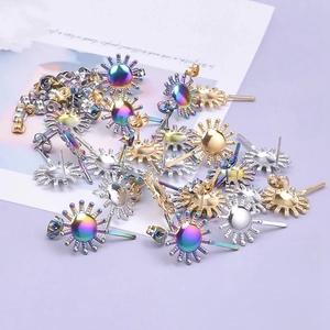 Detailed macro view of sunburst surgical steel earring findings in gold, silver, and rainbow