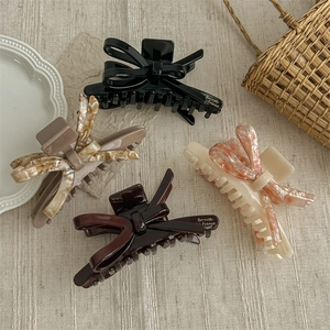 Sweet acetate bow hair claws in black and marble patterns for elegant hair styling