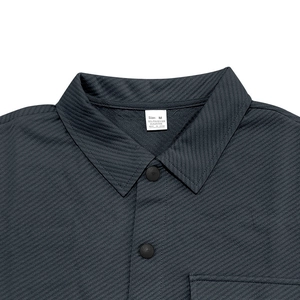 Macro shot of dark grey heavy twill shirt showing fabric texture and buttons
