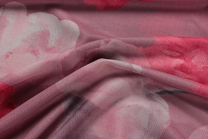 Close-up of floral print mesh fabric showing delicate red rose patterns and soft pleats
