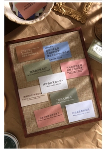 Macro shot of Morandi vintage text stickers on linen background with retro props