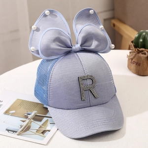 Detail view of light blue mesh baseball cap with pearl bow and rhinestone letter R