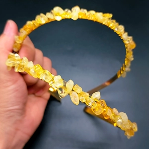 Detail showing handcrafted natural raw crystal fragments on a golden bridal crown headband