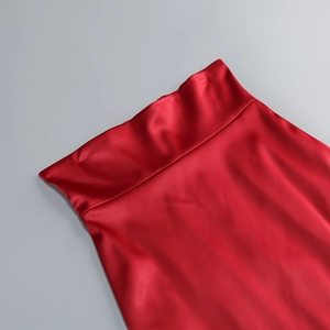 Détail du tissu satiné rouge montrant une texture lisse et une finition brillante