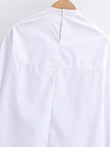Close-up of white blouse collar back featuring neat stitching and a hidden closure
