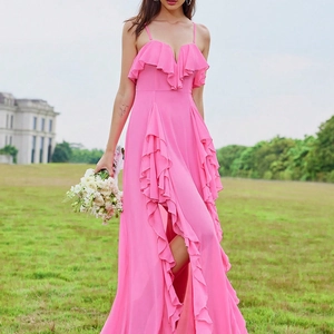 Close-up of fuchsia V-neck evening dress with layered ruffles and high slit detail