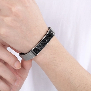 Detail of silver mesh bracelet with black pavé crystal rectangular plate on wrist