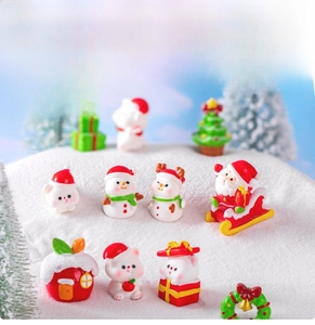Miniature Christmas resin figurines set featuring Santa and bear on snowy background