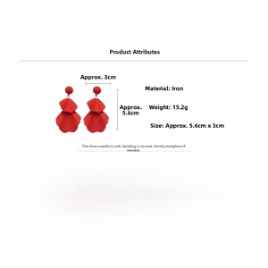Detail view of red hollow petal leaf earrings with silver pins and lacquer finish