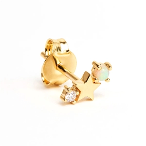 Macro shot of gold S925 sterling silver star stud with opal and zircon stone inlay