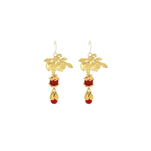 Detail of gold leaf earrings with red bead accents in a vintage Chinese style