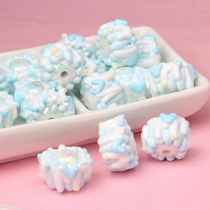 Detail of colorful resin beads with hand-painted patterns for DIY crafts and jewelry