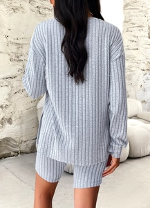 Rear view of a casual grey ribbed knit two-piece set with long sleeves and shorts