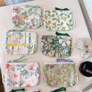 Flat lay view of assorted floral cotton coin purses with simple wish labels and zippers